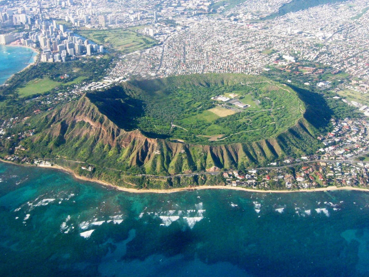 Aerial of Diamond Head and the Honolulu coastline — the kind of Hawaiʻi parcel KILO reads, one at a time.